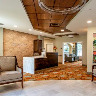 A modern and stylish reception area with cozy seating and elegant lighting.