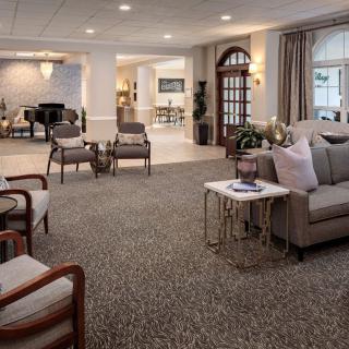 A spacious and elegantly furnished living room featuring comfortable seating and tasteful decor.