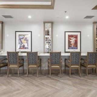 A modern office waiting area with chairs and framed artwork on the walls.