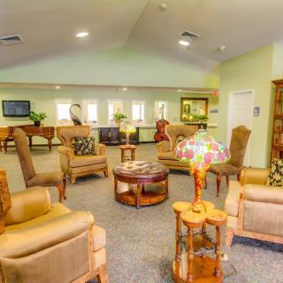 A cozy lounge area with comfortable seating and tables.