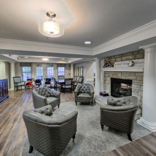 A modern living room featuring a comfortable seating area with a fireplace and elegant interior design.