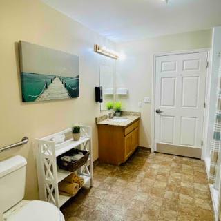 A serene and modern bathroom featuring a stylish vanity, clean lines, and artistic touches.