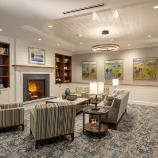 A cozy living room with a fireplace, comfortable seating, and stylish decor.