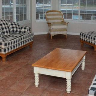 A cozy living room with checkered sofas and a wooden coffee table.