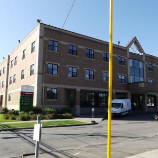A modern commercial building with a clear blue sky in the background.