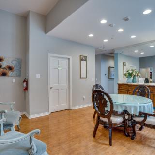 A cozy dining area with a round table and chairs adjacent to a kitchen space.