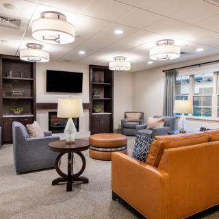 A modern living room with comfortable seating and stylish lighting fixtures.