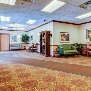 A spacious lobby area with seating arrangements and decorative elements.