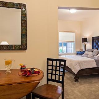 A cozy bedroom view with a small table and stylish decor.