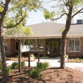 A charming residential building surrounded by greenery.