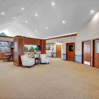 A modern lobby interior with comfortable seating and wooden accents.