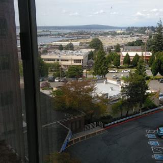 A scenic view from a window showcasing a blend of urban and natural landscapes.