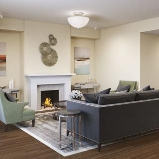 A modern living room featuring a cozy fireplace and stylish seating arrangement.