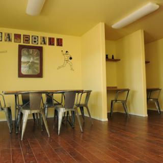 A cozy dining area featuring yellow walls and stylish metal chairs, perfect for casual gatherings.