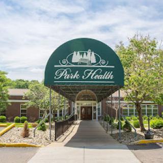 The entrance of Park Health, showcasing a welcoming facade surrounded by nature.