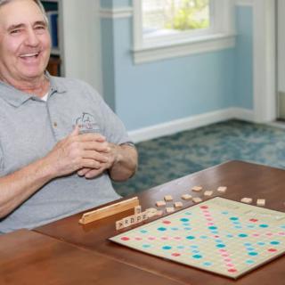 A man enjoying a game of Scrabble indoors.