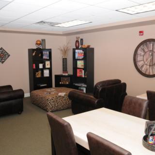 A cozy office meeting room with comfortable seating and decorative elements.