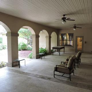 A spacious indoor area featuring elegant arches and comfortable seating.