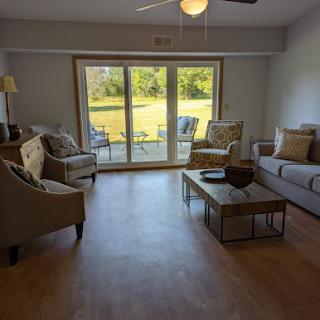 A cozy living room with comfortable seating and a view of the outdoors.