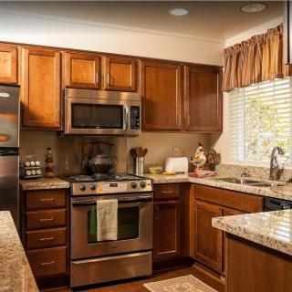 A cozy kitchen with wooden cabinets and stainless steel appliances.