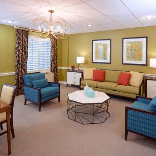 A cozy and stylish living room with colorful furniture and elegant decor.