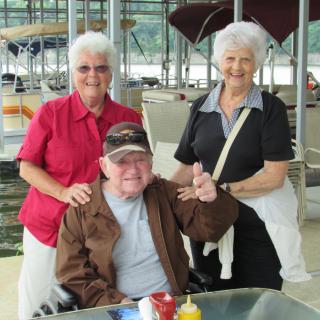 A group of three elderly individuals enjoying a day out together.