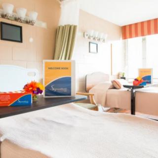 A cozy and modern hotel room with comfortable seating and elegant decor.