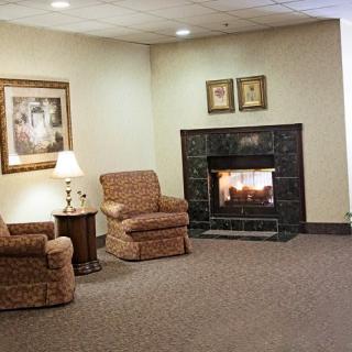 Cozy seating area with armchairs and a fireplace.