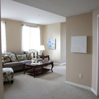 A cozy living room with a neutral color scheme, featuring a comfortable sofa and a wooden coffee table.