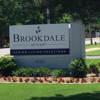 Sign for Brookdale Senior Living Solutions in a landscaped area.