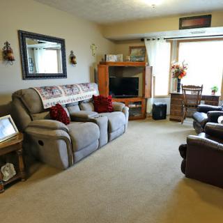 A cozy living room featuring comfortable seating and warm decor.