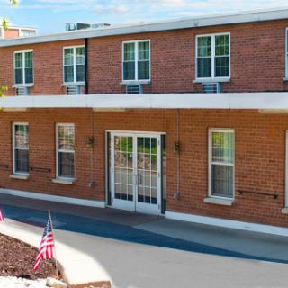 A charming brick building with a welcoming entrance and well-maintained surroundings.