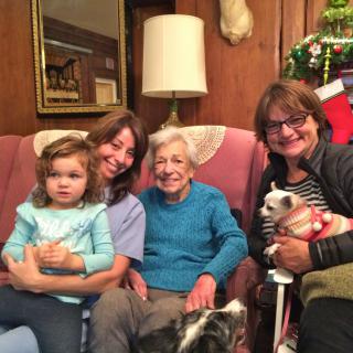 A family enjoying a cozy moment together in the living room, surrounded by holiday decorations.