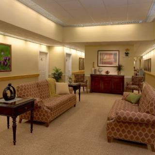 A well-lit waiting room with comfortable seating and elegant decor.