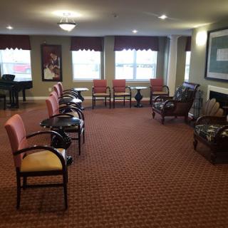 A spacious waiting area featuring various seating options and warm lighting.