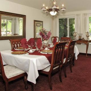 Elegantly set dining room with traditional decor and a chandelier.