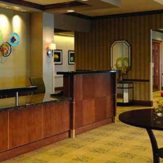 A hotel lobby with a reception desk and stylish interior design.