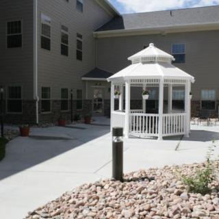 A courtyard featuring a white gazebo surrounded by a building.