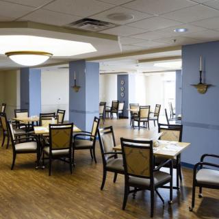 A spacious dining area with neatly arranged tables and chairs.