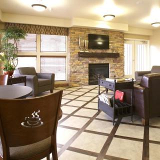 A cozy living room with a fireplace, television, and comfortable seating.