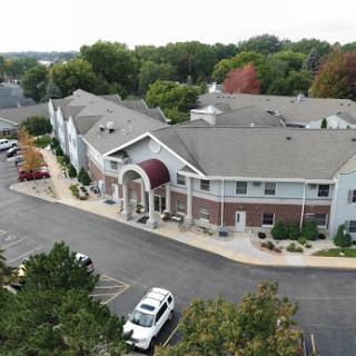 Aerial view of a residential building with a landscaped parking area.