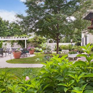 A beautiful garden with outdoor seating and lush greenery.
