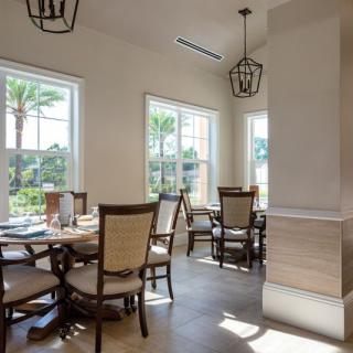 A bright and airy dining area with elegant seating and large windows.