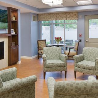 A modern waiting room with comfortable chairs and natural lighting.