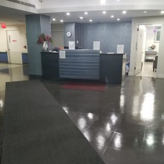 A modern reception area with polished floors and a sleek design.