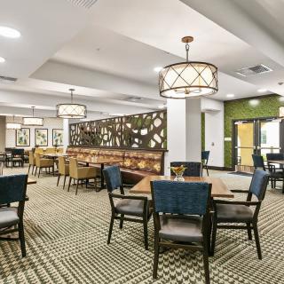 A modern dining area with stylish furniture and ambient lighting.