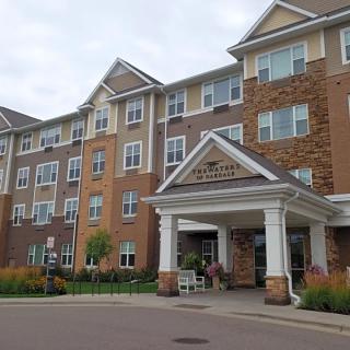 A multi-story residential building with brick and stone facade.