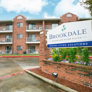 A senior living facility with a prominent sign and brick exterior.