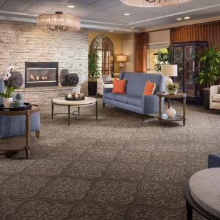 A modern and cozy living room with stylish furniture and a fireplace.