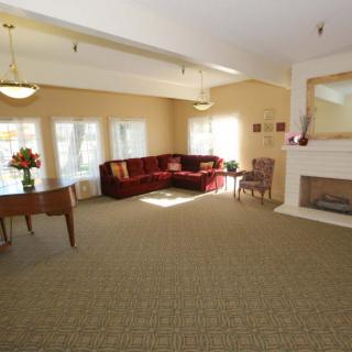 Spacious living room with a cozy red sofa and fireplace.